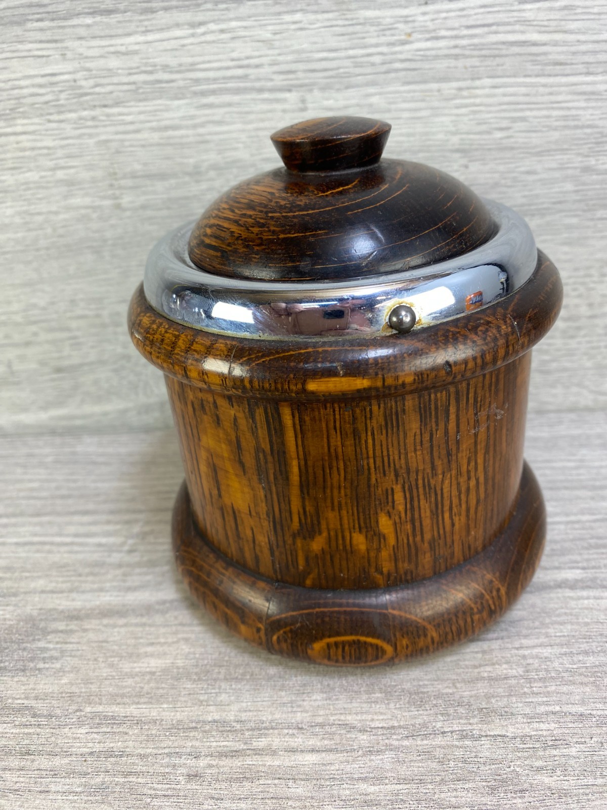 An early 20th century turned oak lidded tobacco jar with ceramic liner.