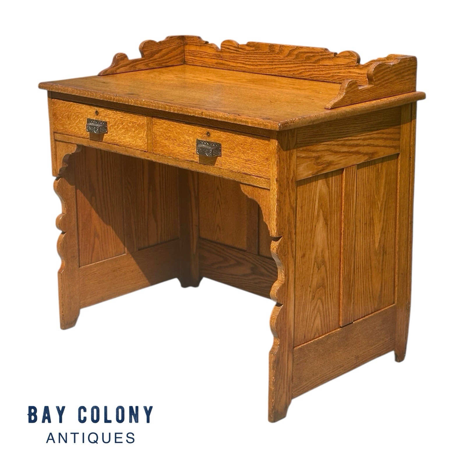 Antique Victorian Tiger Oak Raised Panel Two Drawer Desk with Scrolled Gallery