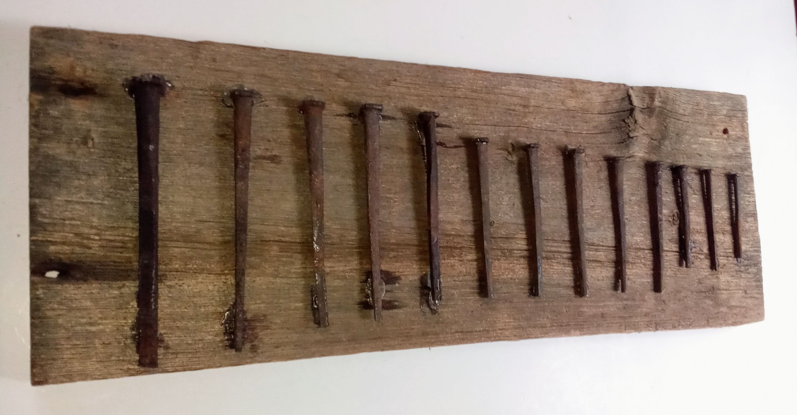 PRE 1800 HAND FORGED IRON NAIL COLLECTION FROM BARN MOUNTED ANTIQUE BOARD PRIMTV