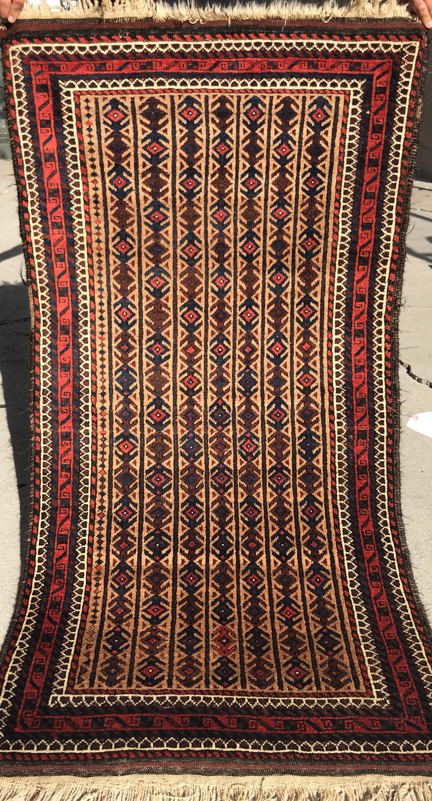 A BEAUTIFUL STRIP DESIGN CAMEL HAIR BACKGROUND COLOR BALOOCH TRIBAL RUG