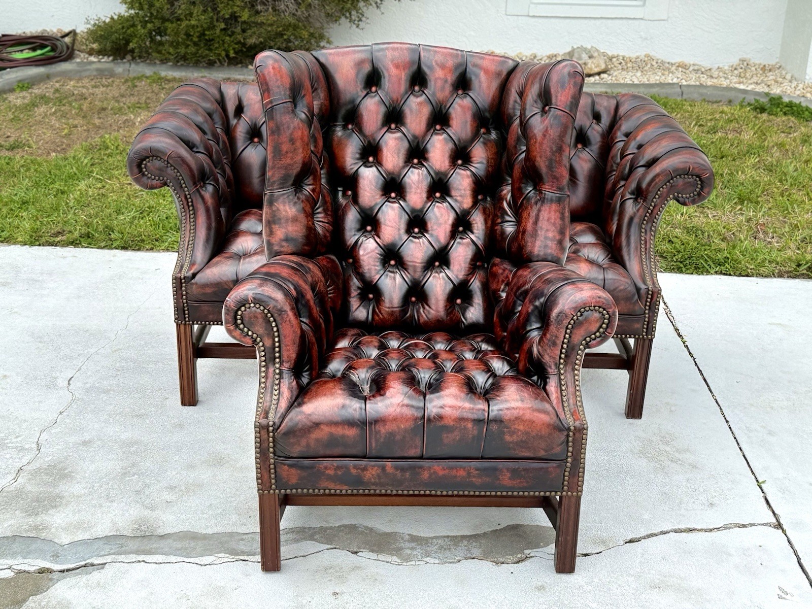Vintage tufted leather camelback chesterfield loveseat and high back wing chair