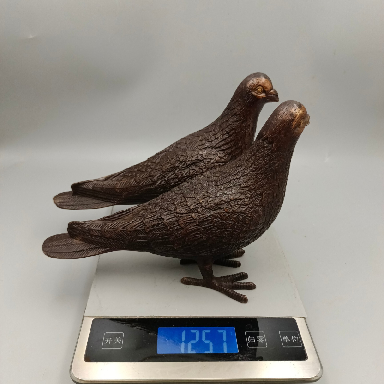 A pair of red copper gilded peace doves