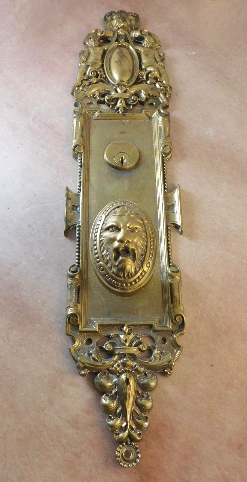 Antique Corbin oval lion doorknob and large plate cast brass bronze 1895 cherubs