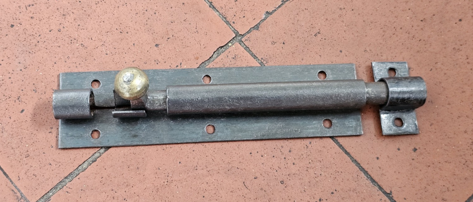 Antique Victorian black iron and brass door bolt with surface mounted keep 1880