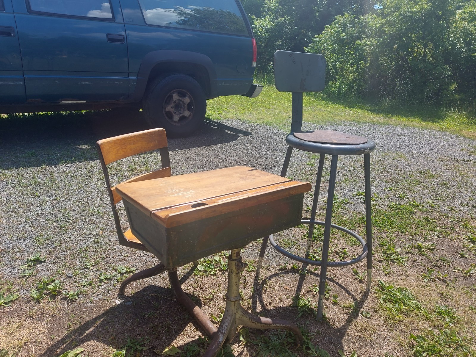 antique 1920s-1940s school desk features a wooden lift-top surface & cast…
