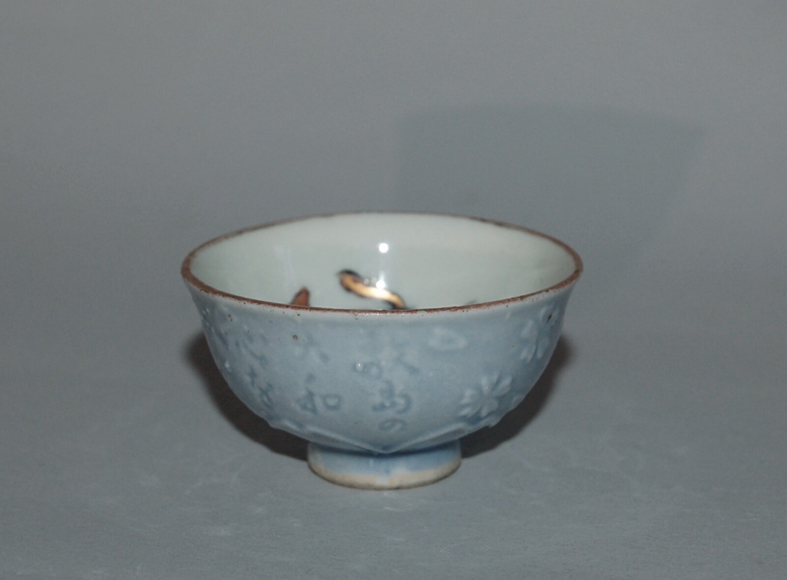 Tiny guinomi sake cup with love-making couple, blossom, poem, porcelain, Japan