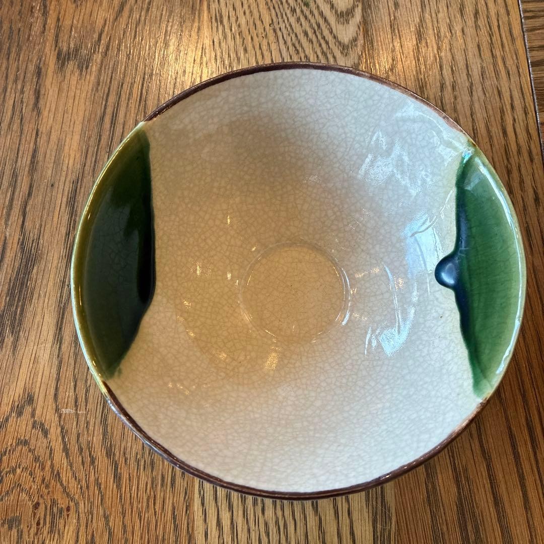 green and cream ceramic bowl