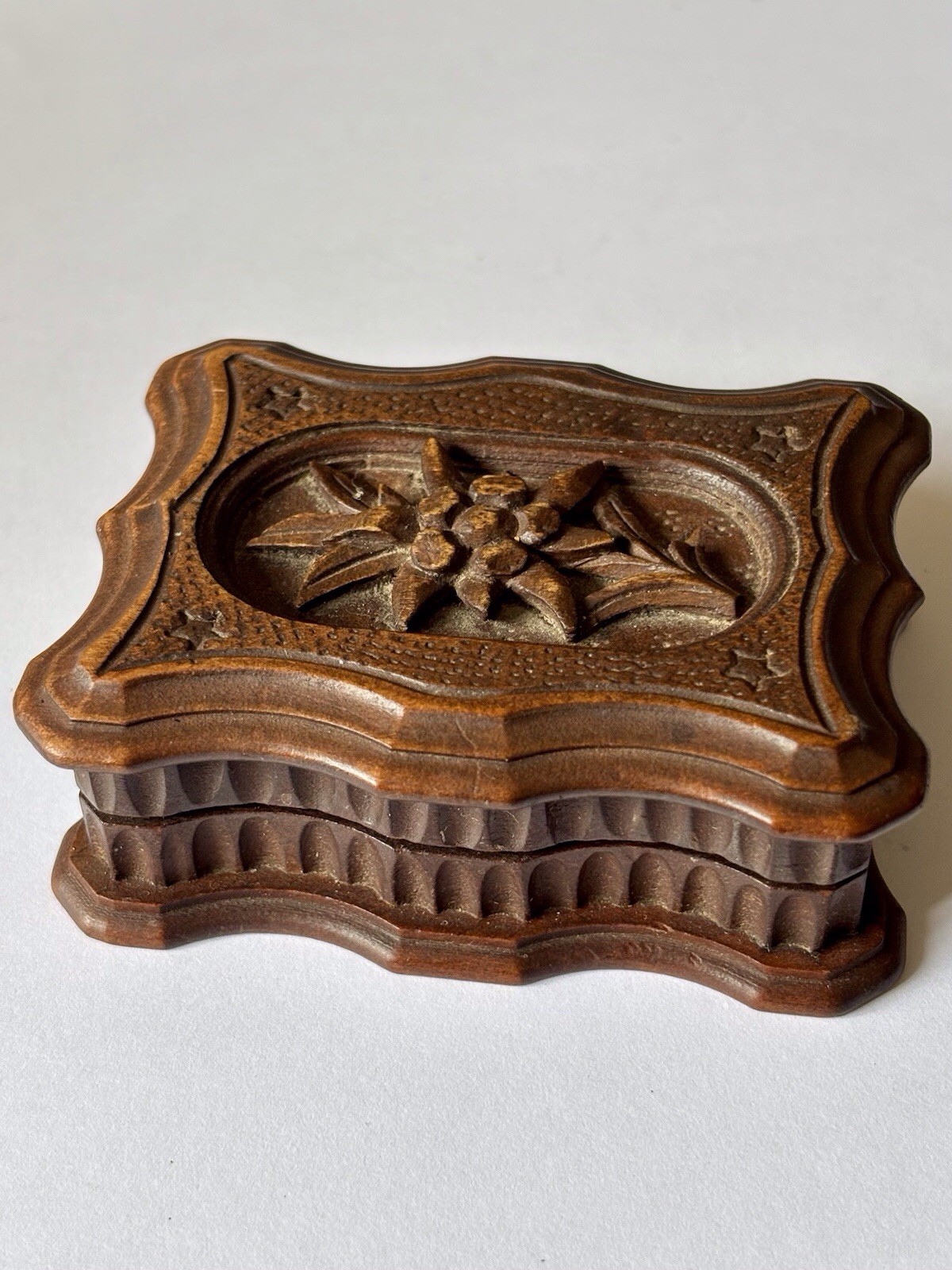 A 19th century Black Forest stamp box, the hinged cover carved with an Edelweiss