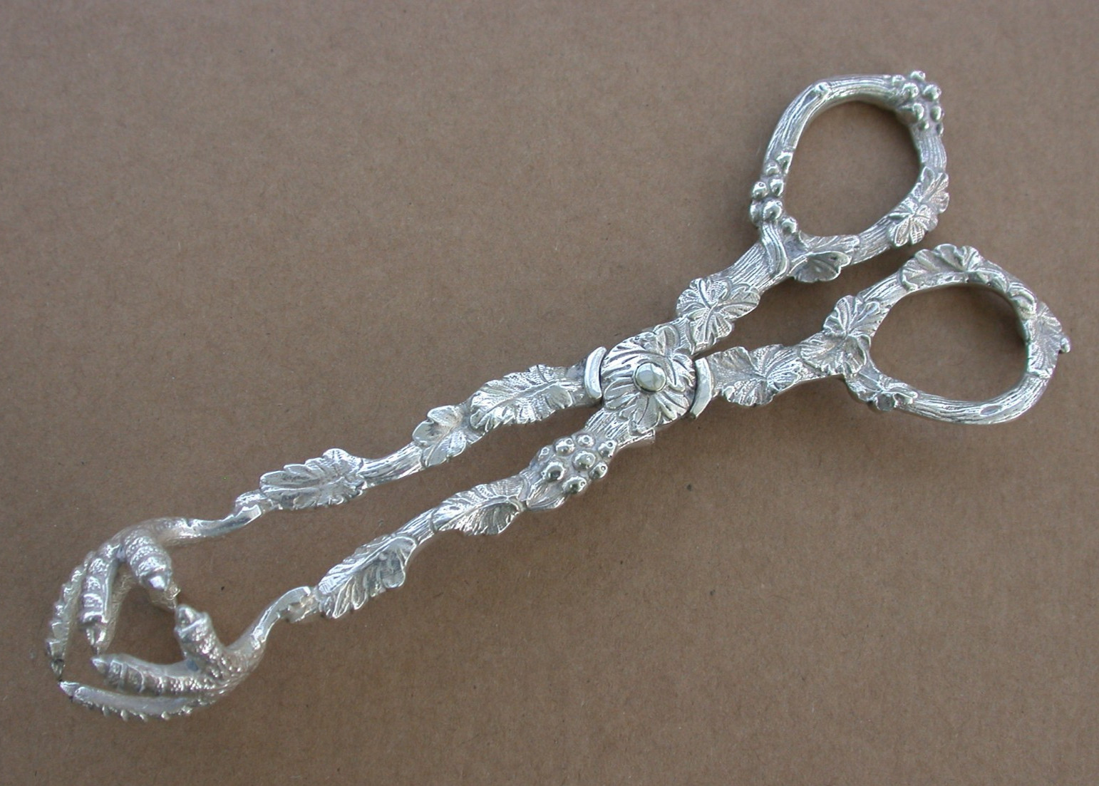 Ornate antique silver sugar nips tongs