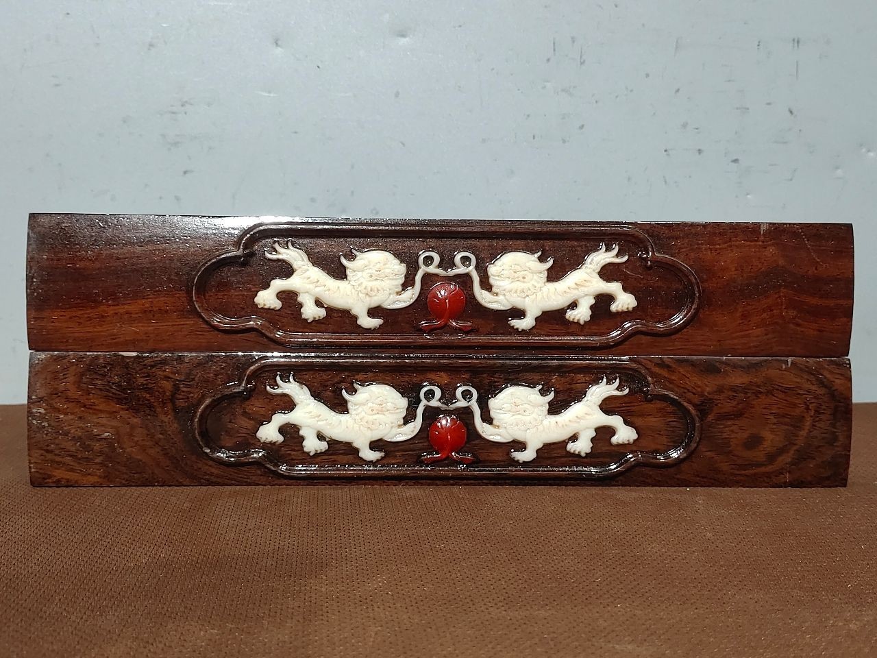 A pair of antique rosewood inlaid with a wealth lion, measuring a square foot