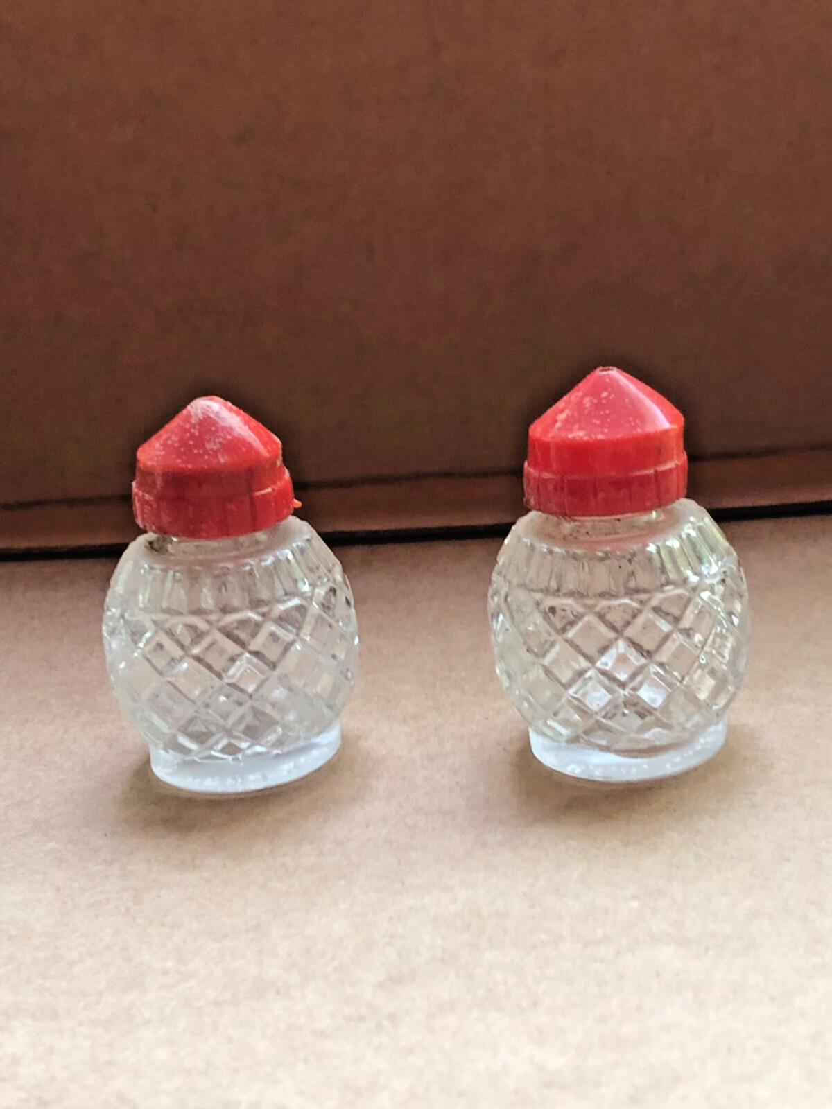 antique petite salt and pepper shakers cut glass with plastic red top 2″ tall