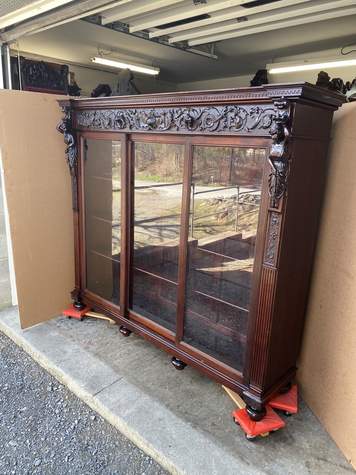 FIGURAL MAHOGANY CARVED TRIPLE DOOR BOOKCASE, ATTR. R. J. HORNER