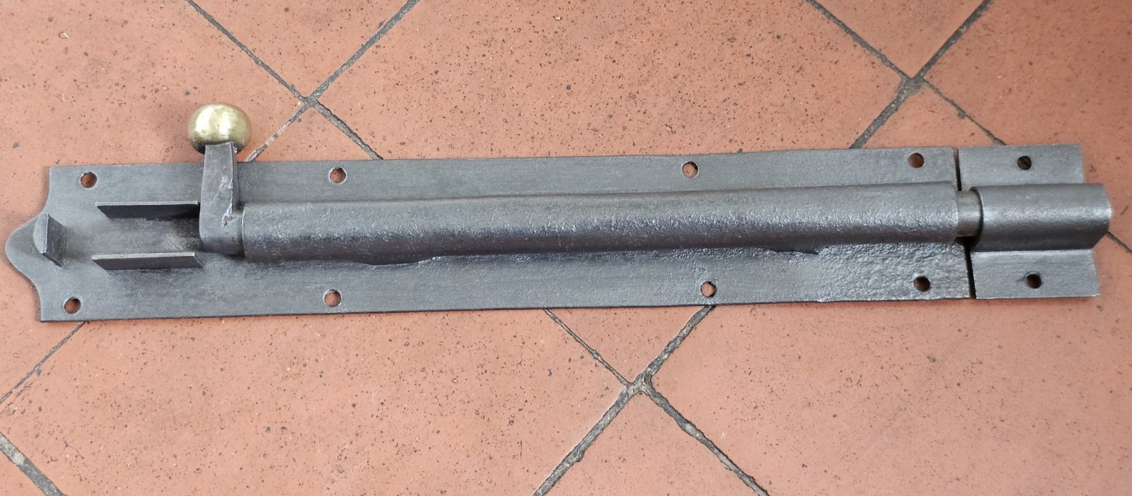 Antique Victorian black iron and brass door bolt with surface mounted keep 1880