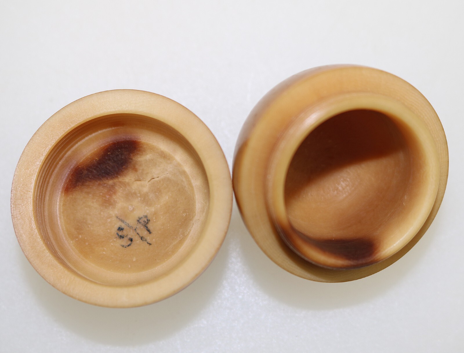 An unusual antique oriental threaded carved nut box on hardstone stand C.1900