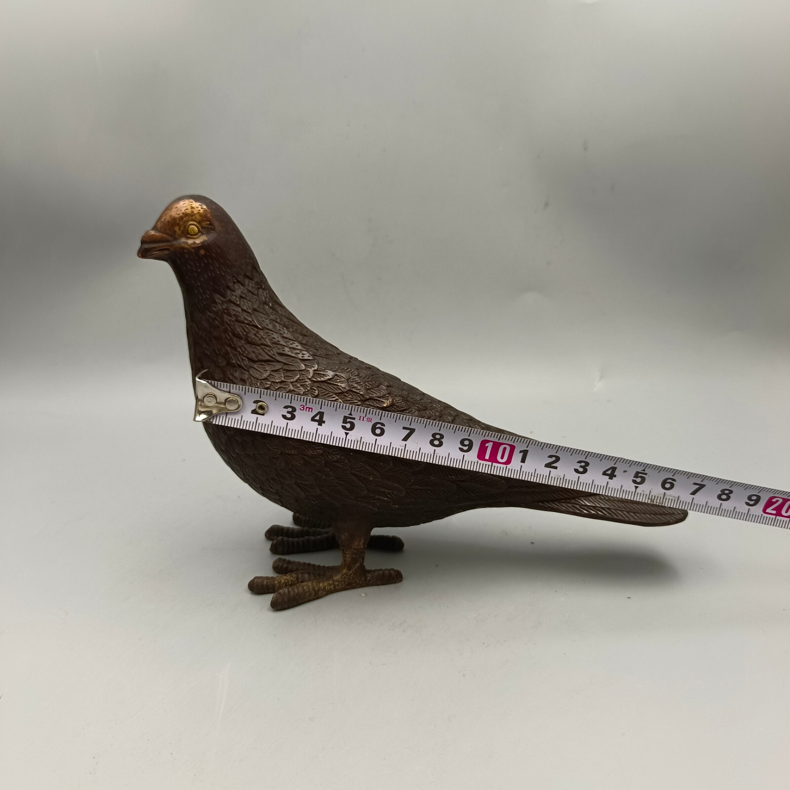 A pair of red copper gilded peace doves