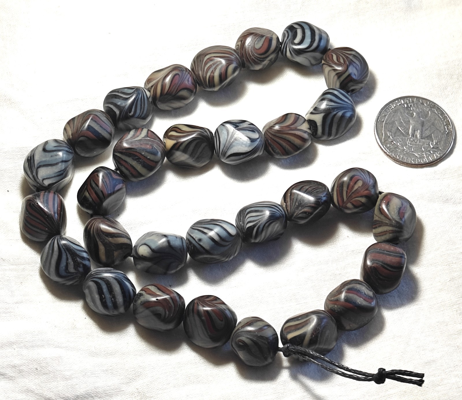 Unusual antique lamp work glass trade bead strand. 128 grams, 18 inches long.