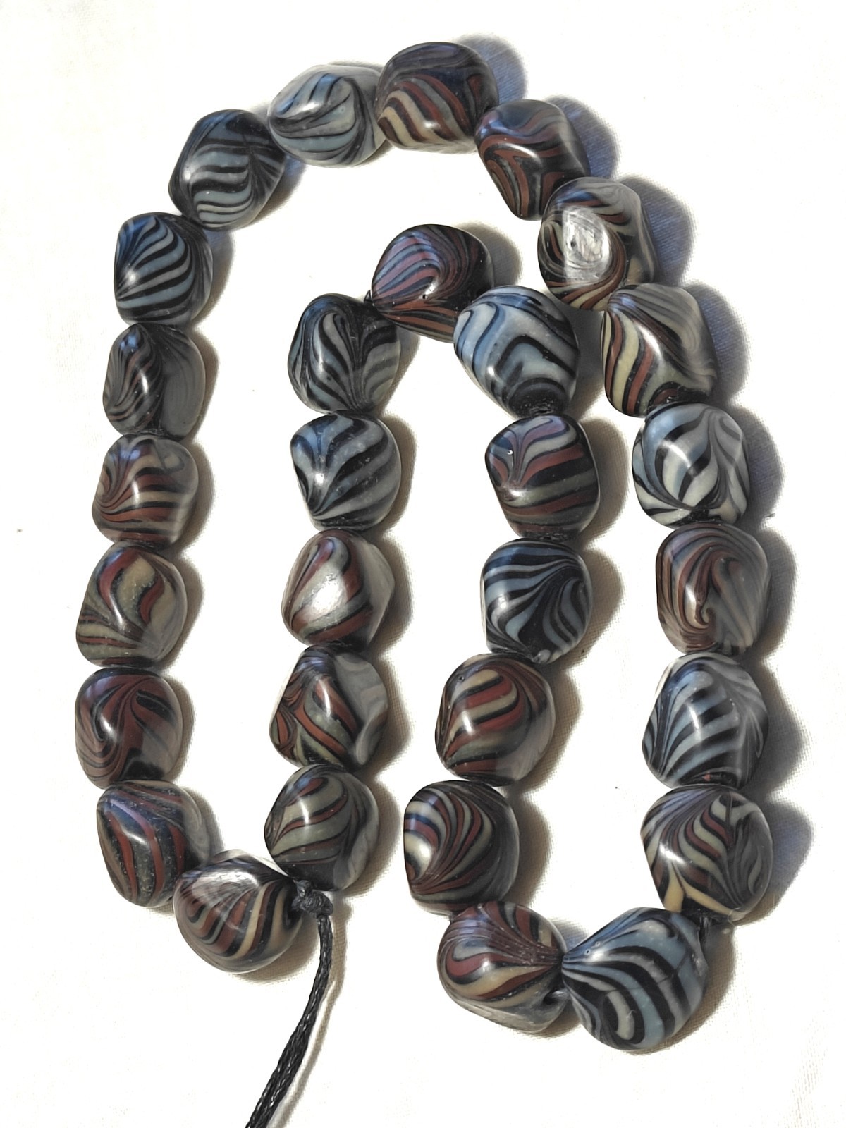 Unusual antique lamp work glass trade bead strand. 128 grams, 18 inches long.
