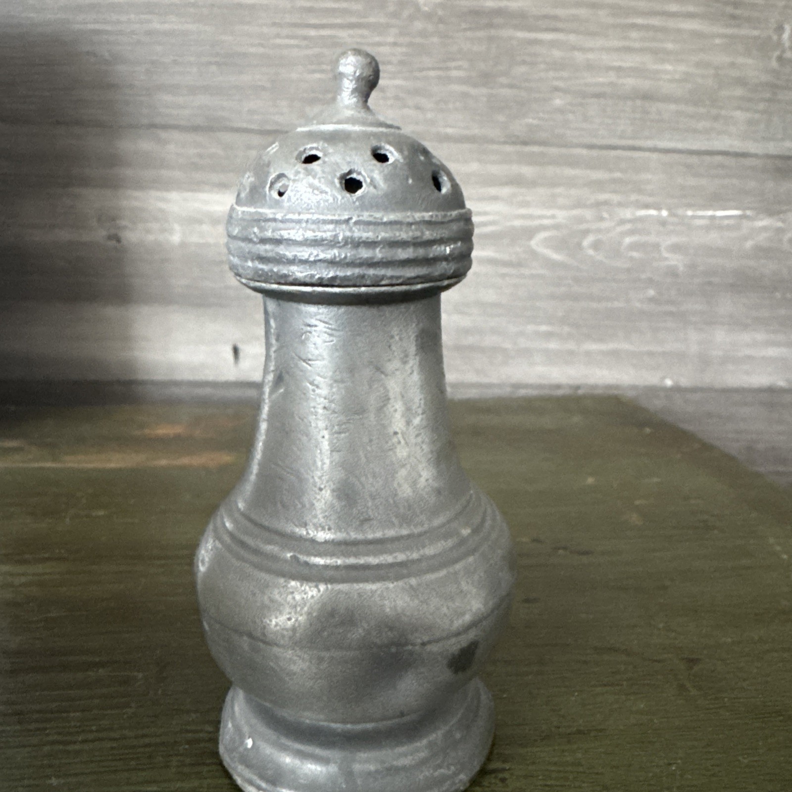 19th century pewter pepper pot 4.5’ high, pot bellied shape with screw on castor