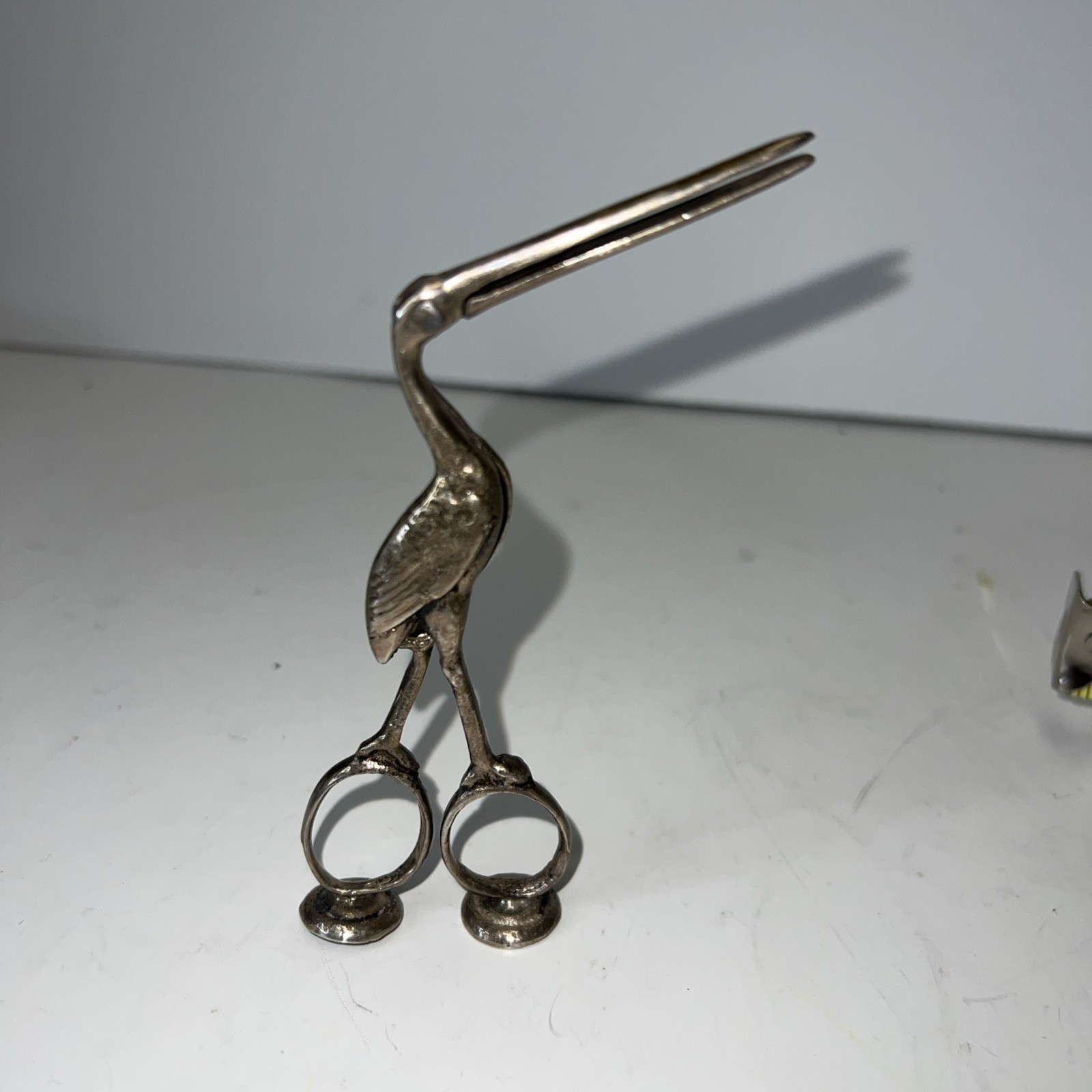 Rare Antique Silver Toned Stork Bird Clamp Scissors with Baby Inlay.