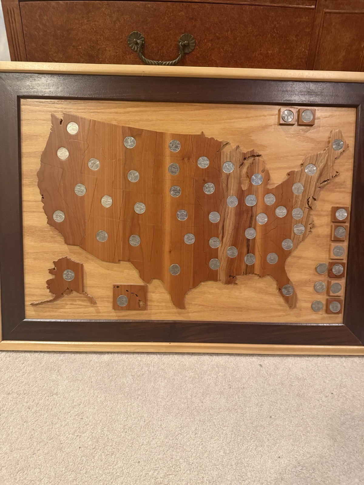 Complete set of the United States quarters inset in wooden map of the US