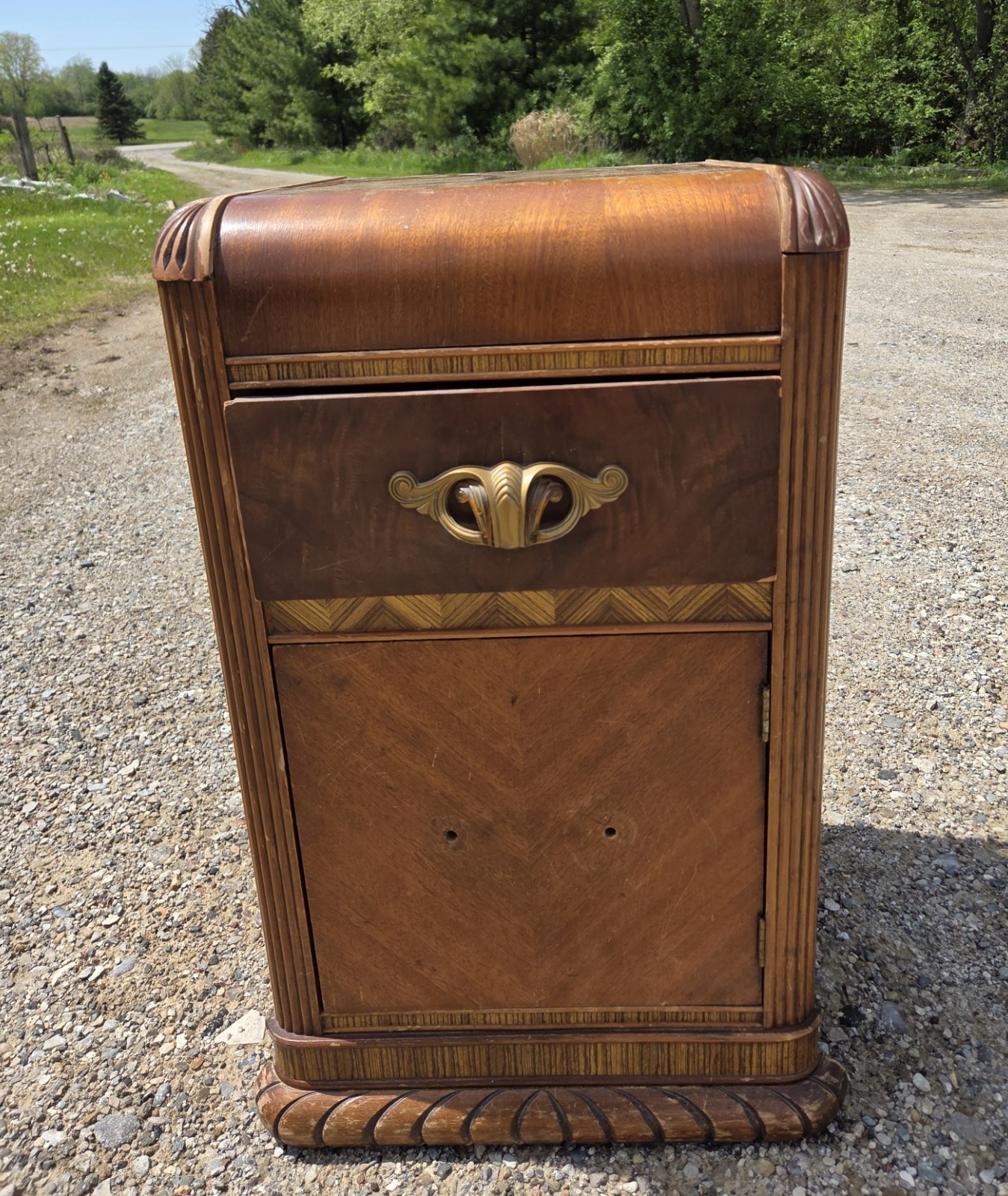 1930s-1940s Art Deco waterfall nightstand featuring walnut and mahogany veneers